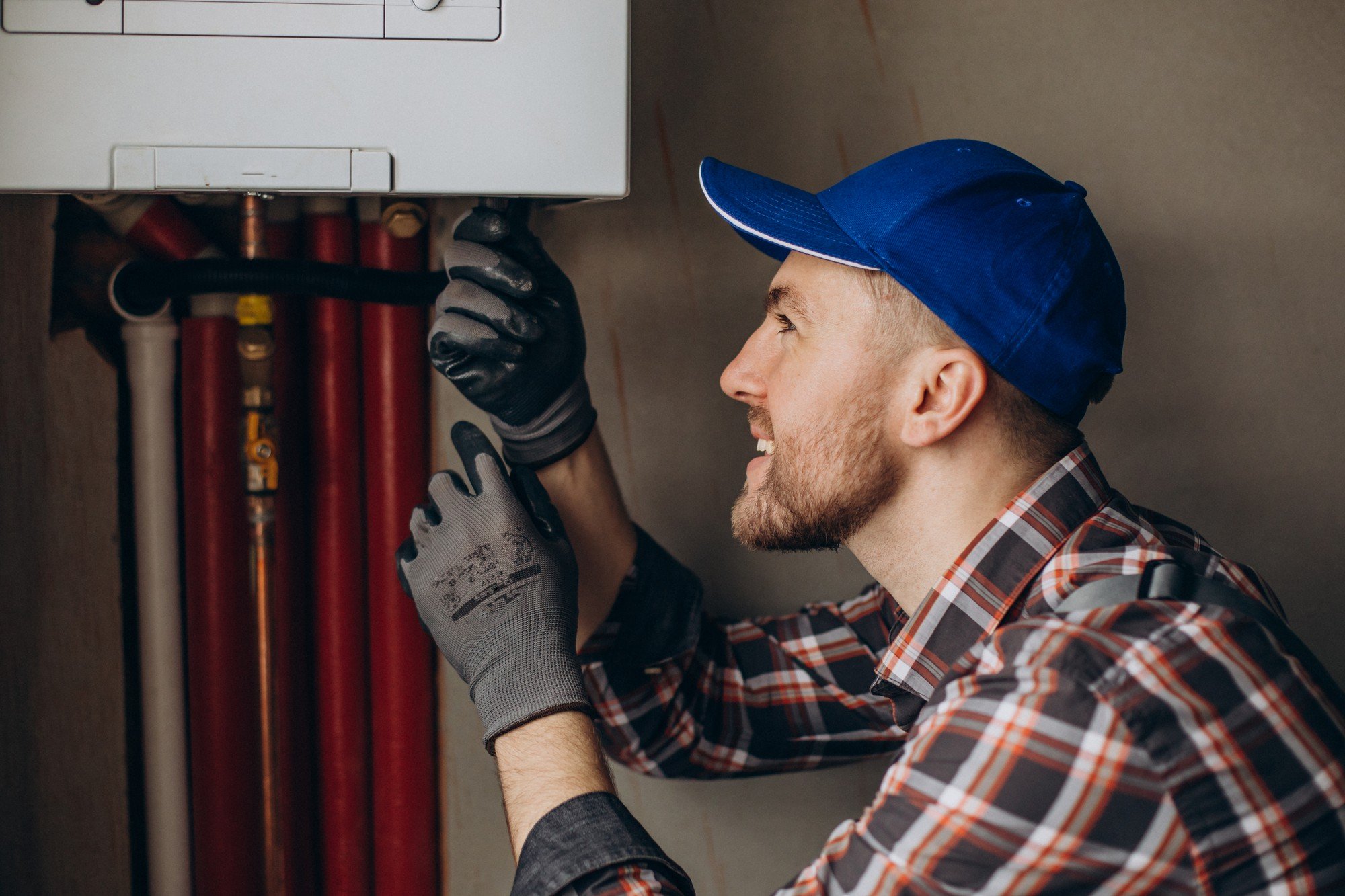 service-man-adjusting-house-heating-system service-man-adjusting-house-heating-system